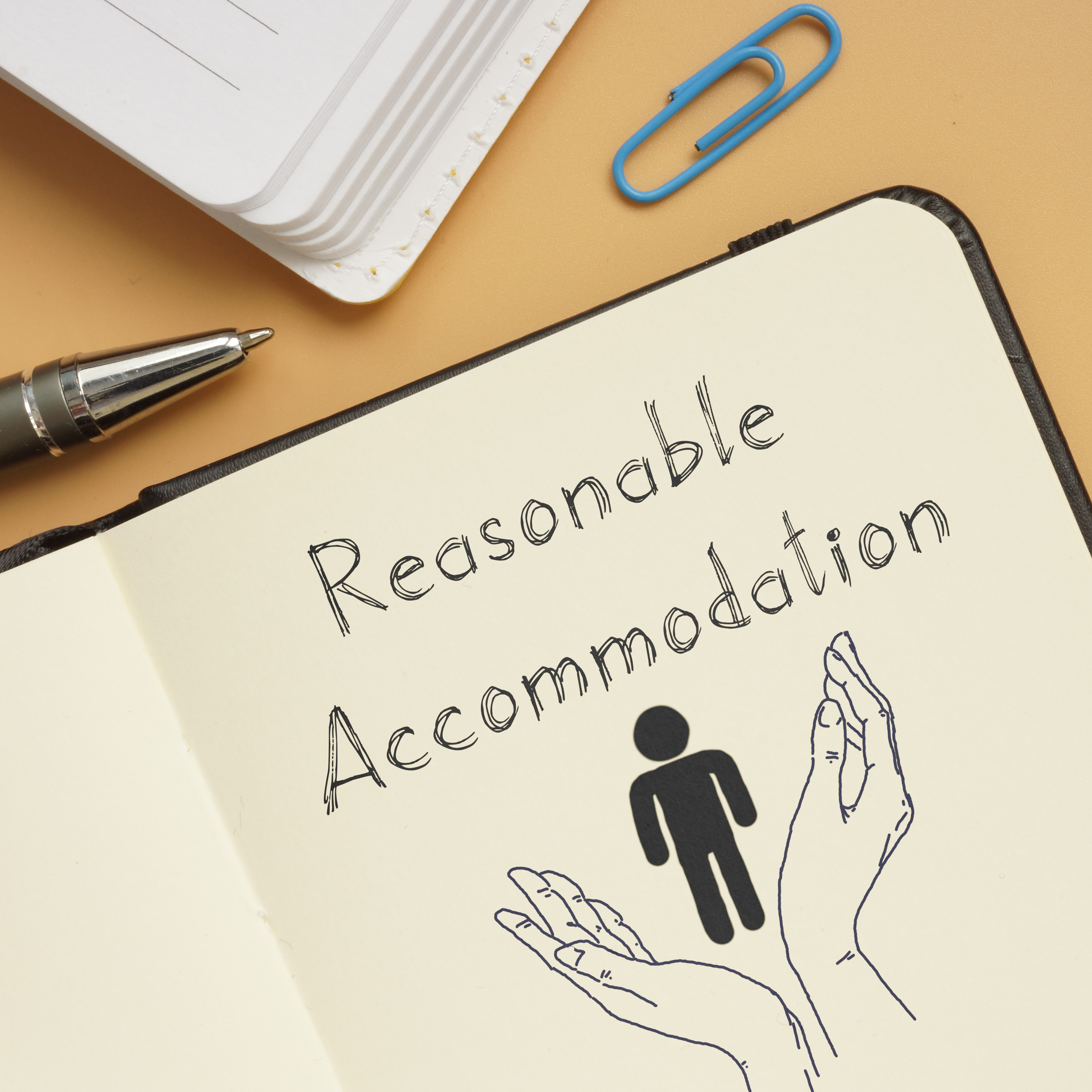 Note pad with words Reasonable Accommodations